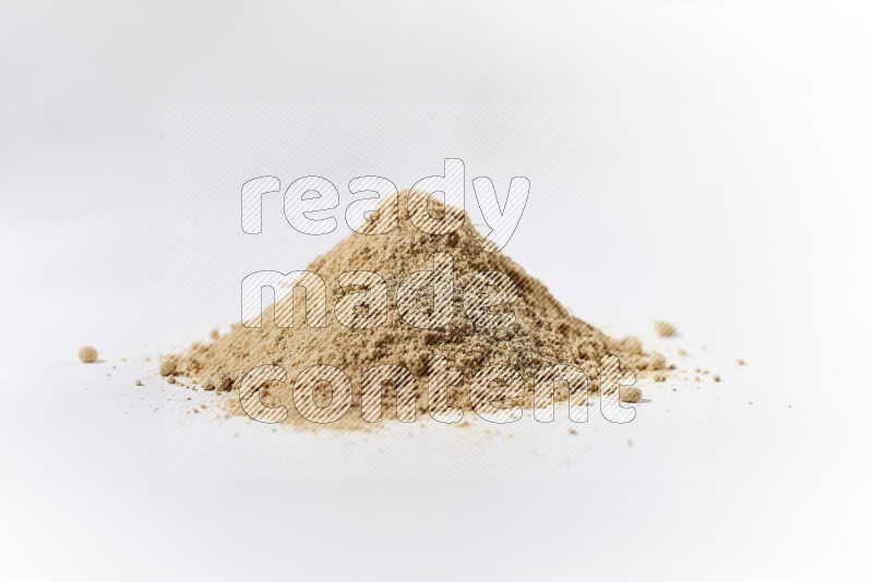 A bunch of ground ginger powder on white background