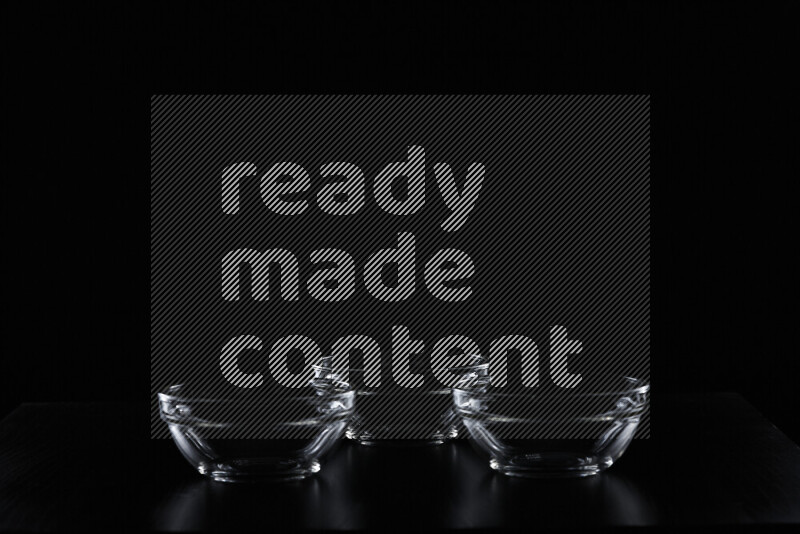 Glassware with rim light against black background