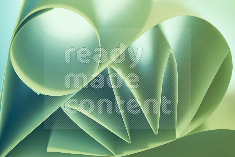 An artistic display of paper folds creating a harmonious blend of geometric shapes, highlighted by soft lighting in green tones