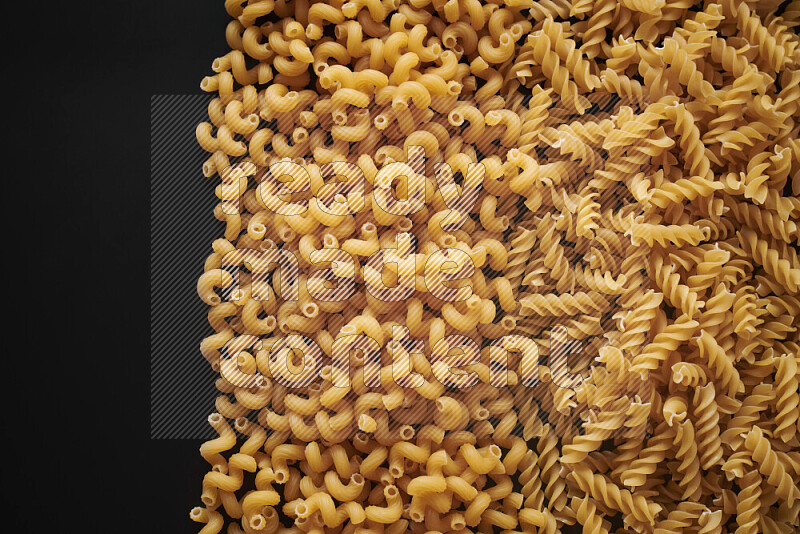 Different pasta types on black background