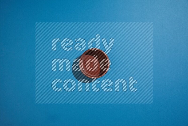 brown bowl on blue background