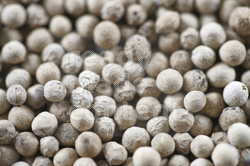 White pepper beads on white background