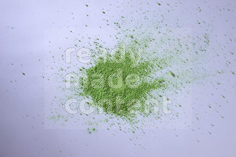 Green powder on white background