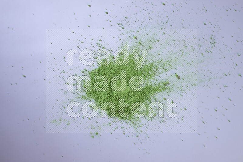 Green powder on white background