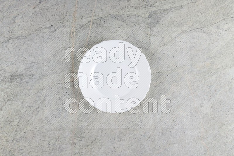 Top View Shot Of A White Ceramic Circular Plate On Grey Marble Flooring