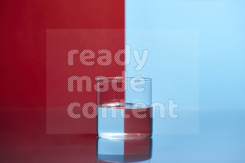 The image features a clear glassware filled with water, set against red and light blue background