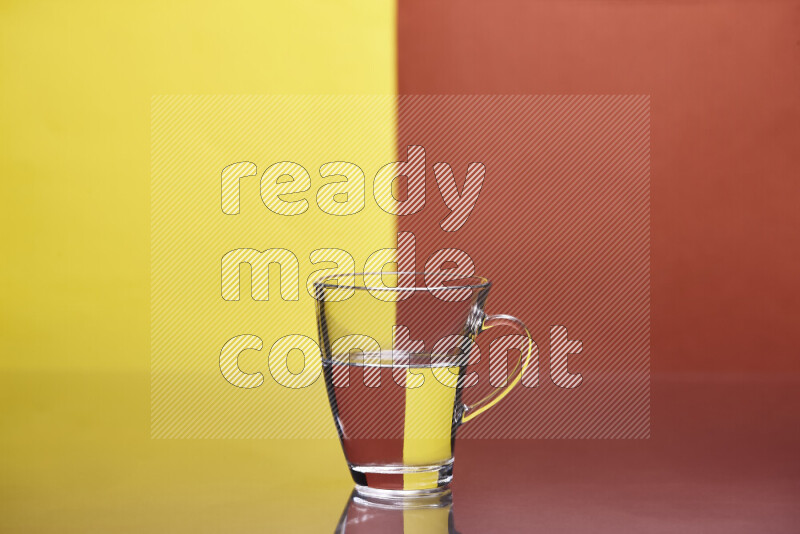 The image features a clear glassware filled with water, set against yellow and dark orange background
