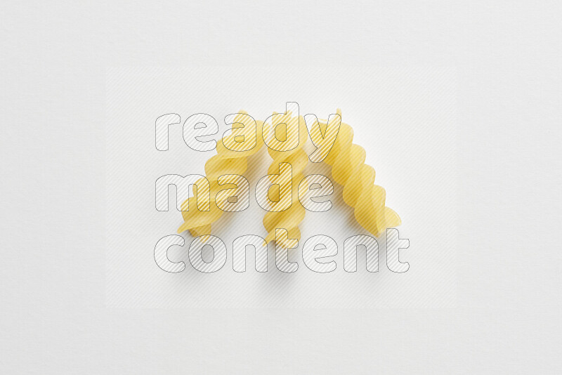 Fusilli pasta on white background