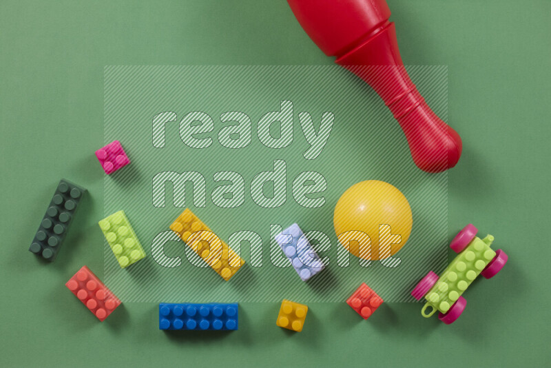 Plastic building blocks, balls and bowling pins on different colored backgrounds (kids toys)