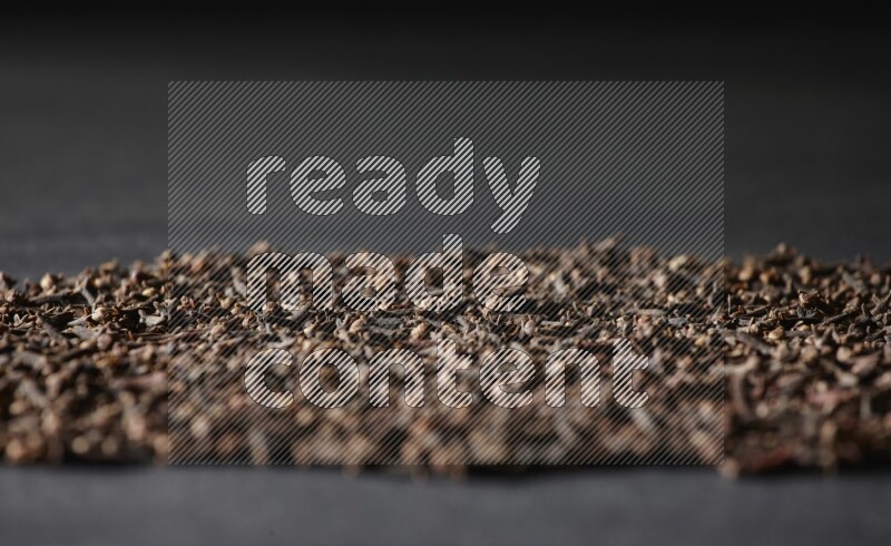 Cloves spread on black flooring