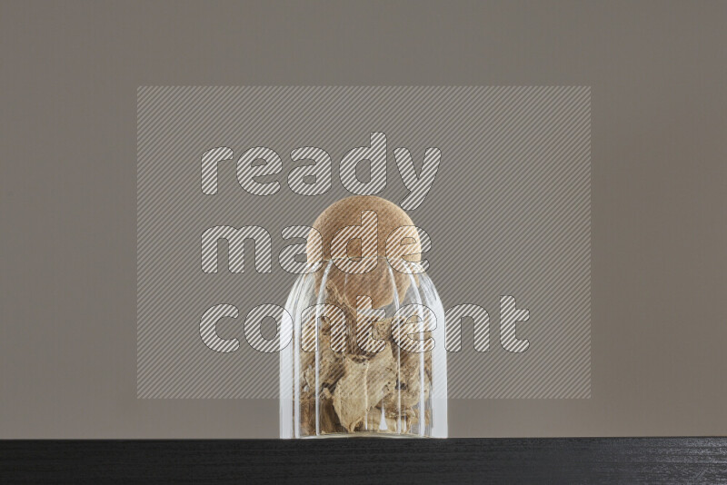 Dried ginger in a glass jar on black background