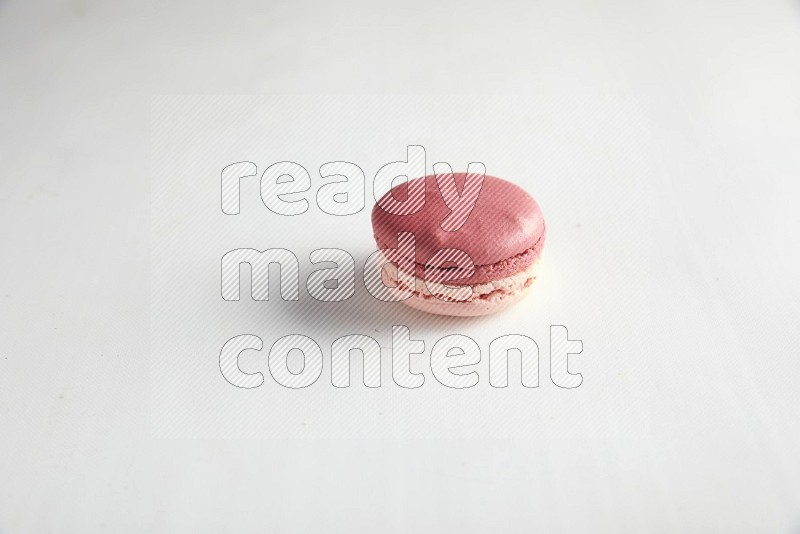 45º Shot of Pink Litchi Raspberry macaron on white background