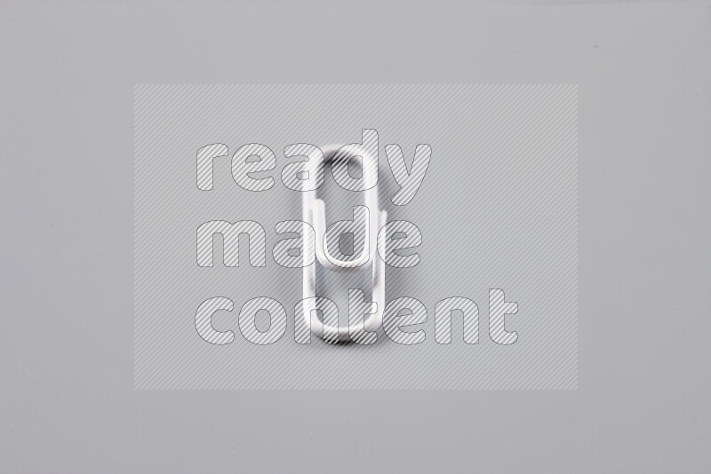 White paperclips isolated on a grey background