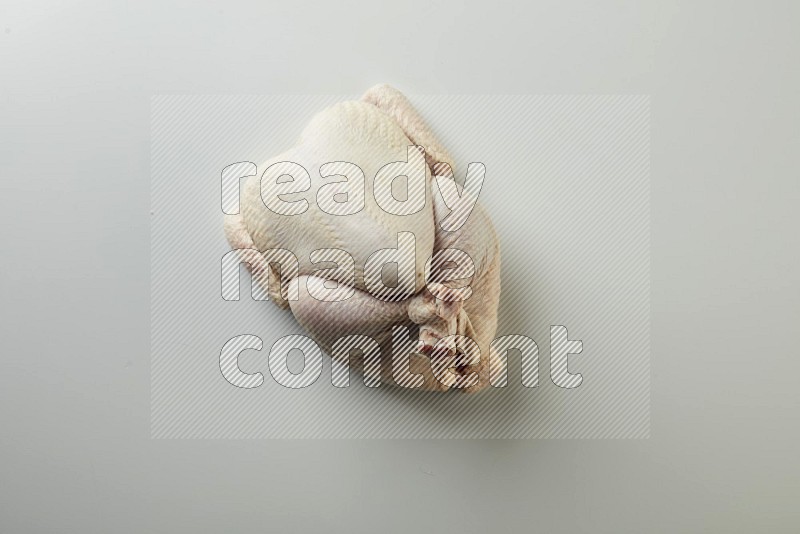 Whole fresh chicken direct on a white background