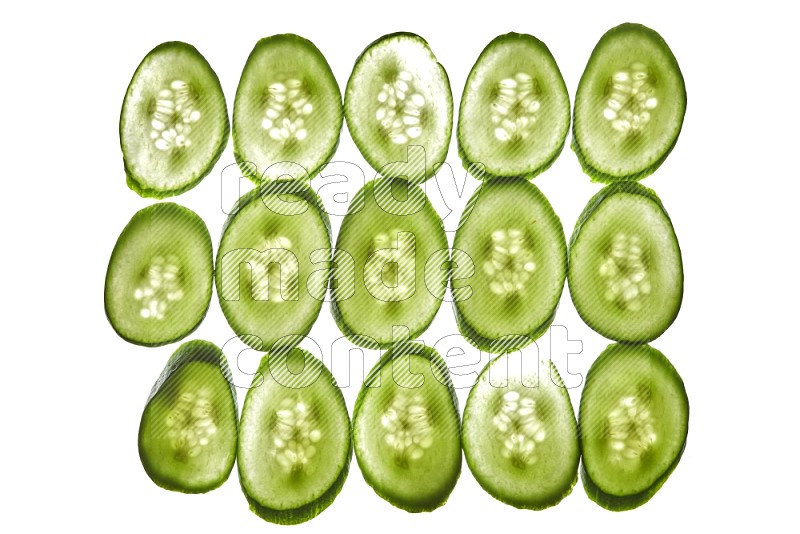 Cucumber slices on illuminated white background