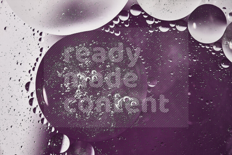 Close-ups of abstract oil bubbles on water surface in shades of white and purple