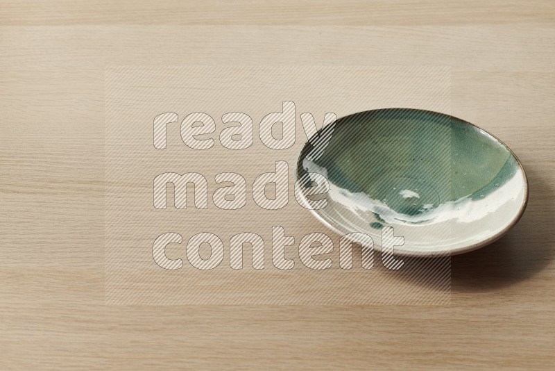 Multicolored Pottery Plate on Oak Wooden Flooring, 45 degrees