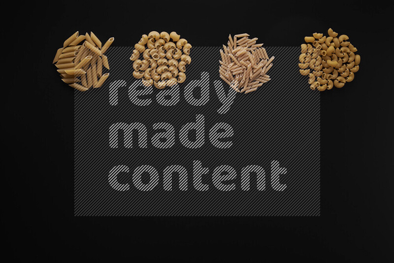 Different pasta types in 4 bunches on black background