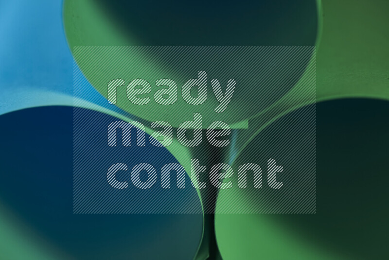 The image shows an abstract paper art with circular shapes in varying shades of green and blue