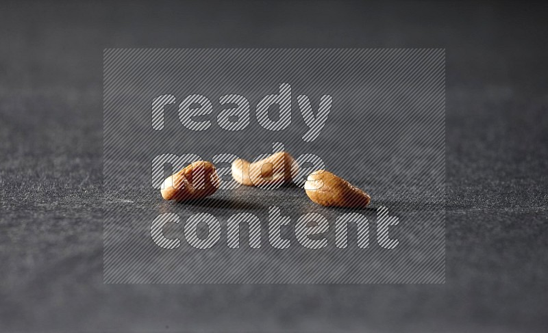 3 cashews on a black background in different angles