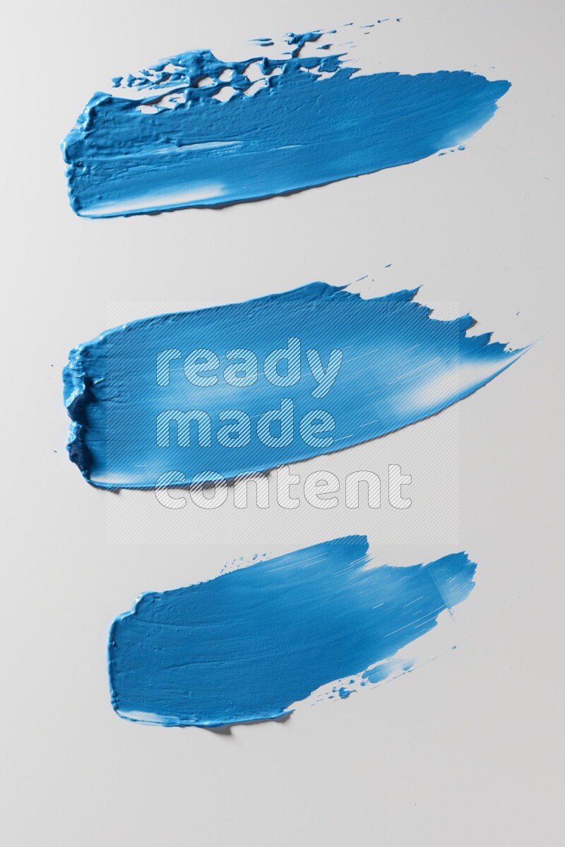 Blue painting knife strokes on a white background