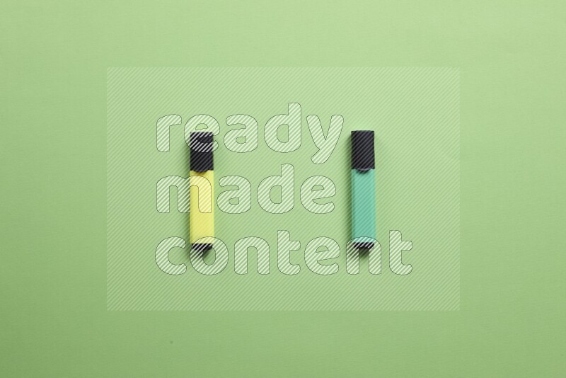 Multicolored highlighter pens on green background