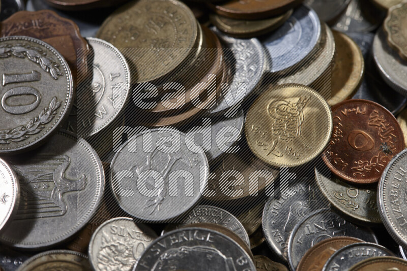 A close-ups of random old coins on black background