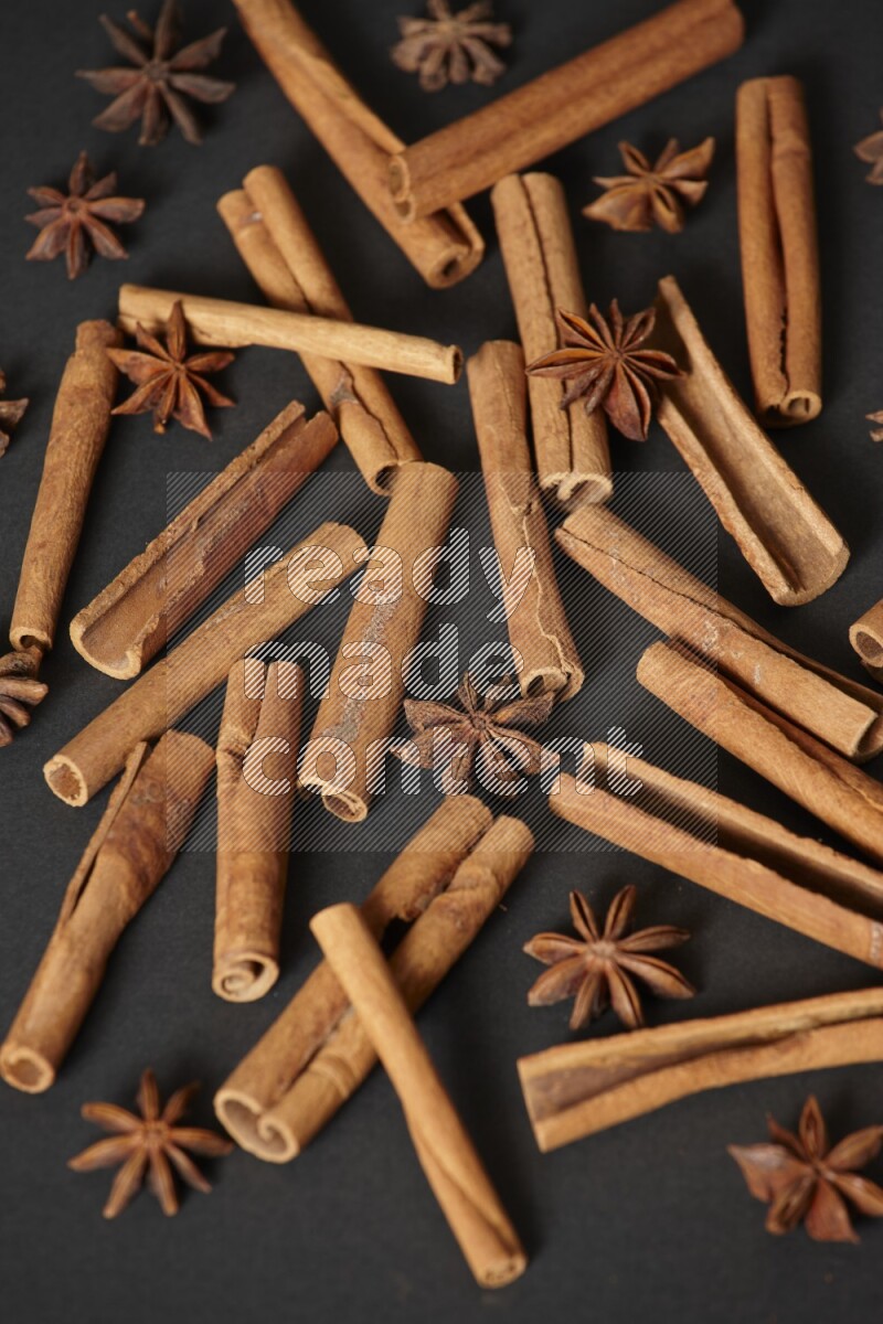 Cinnamon sticks and star anise on black background