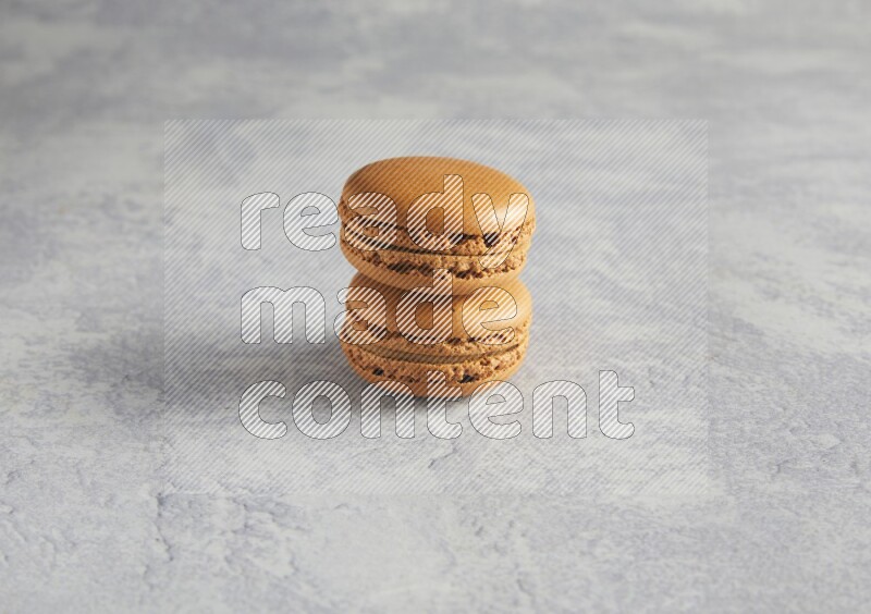 45º Shot of two Brown Maple Taffy macarons  on white  marble background