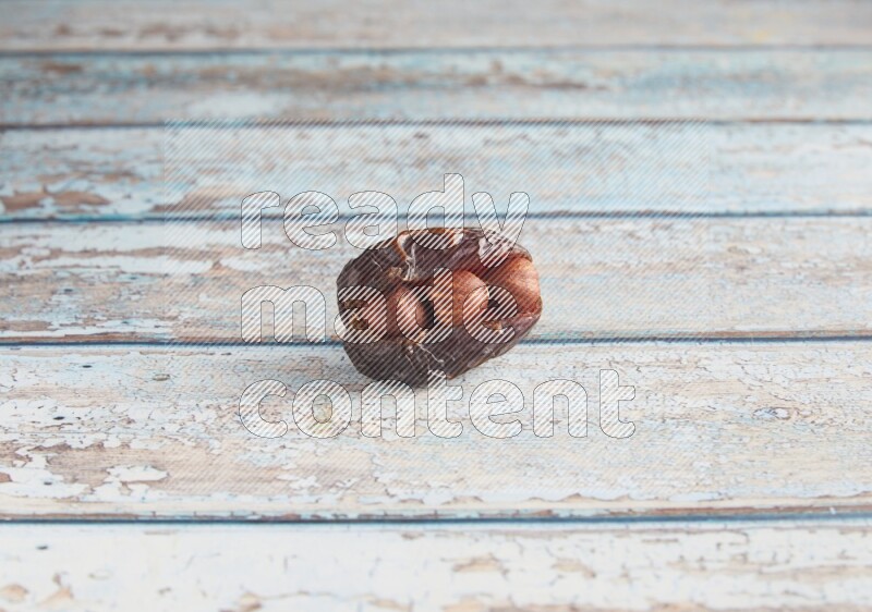 hazelnuts stuffed madjoul date on a light blue wooden background