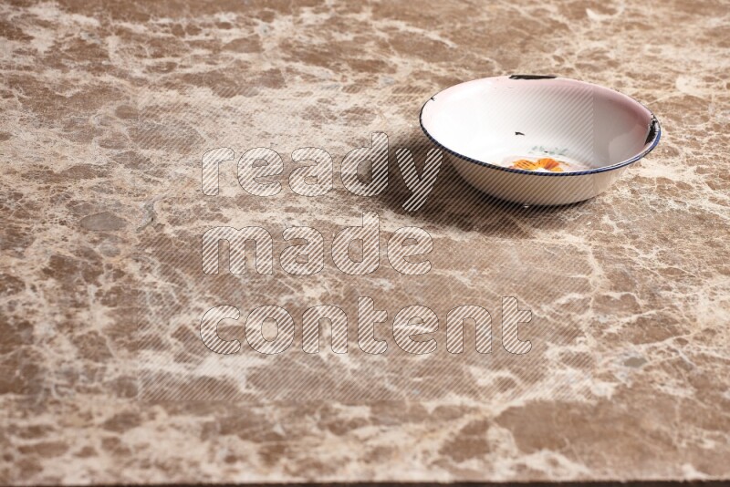 A vintage metal plate on beige marble background