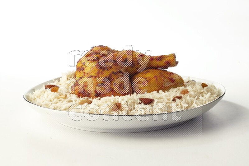 white basmati Rice with kabsa chicken pieces on a white plate with a silver rim direct on white background
