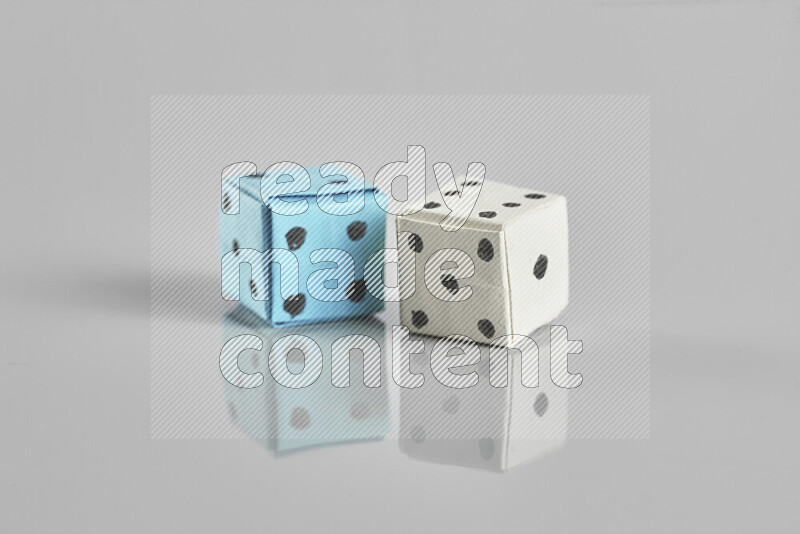 Origami dice on grey background