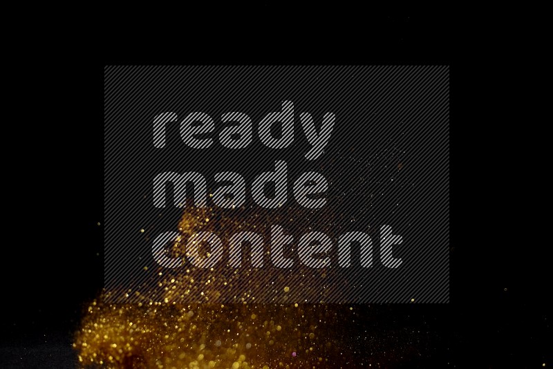 Gold glitter powder isolated on black background