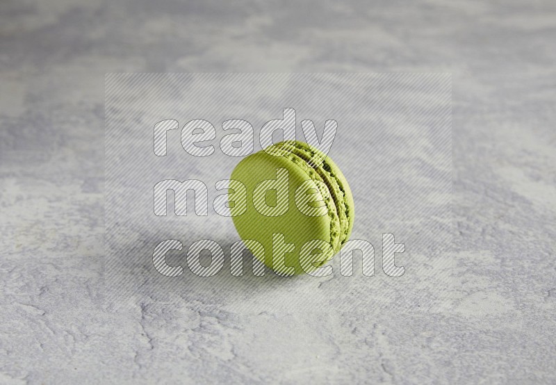 45º Shot of Yellow Lime macaron on white  marble background