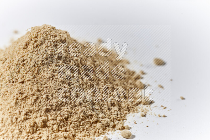 A bunch of ground ginger powder on white background