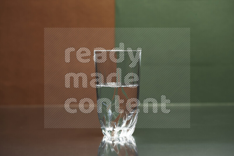 The image features a clear glassware filled with water, set against brown and dark green background