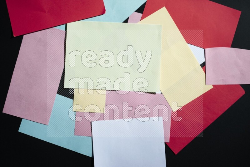 Multicolored paper sheet on black background
