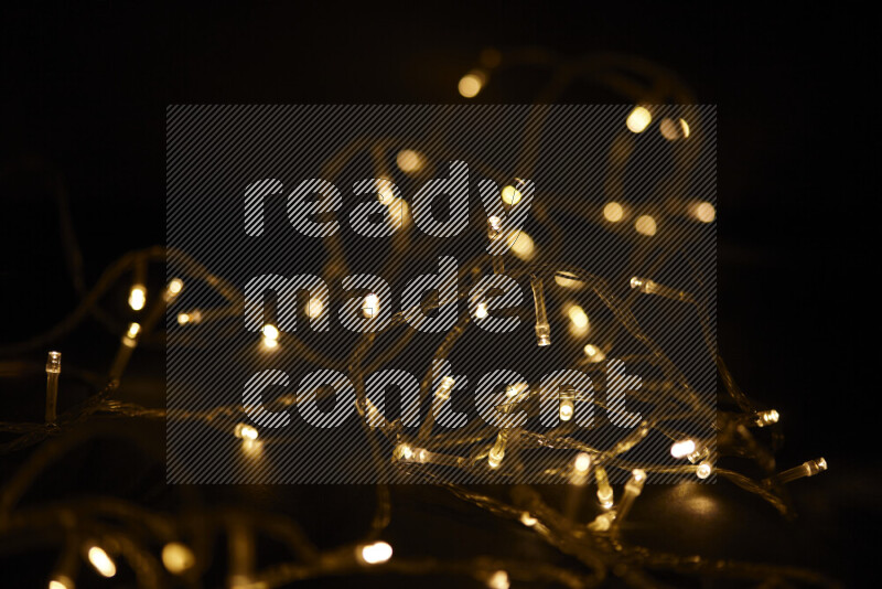 Light bulbs glowing against backdrop of golden bokeh