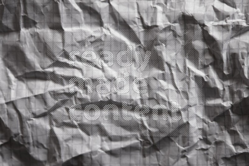 Crumpled notebook sheet on black background
