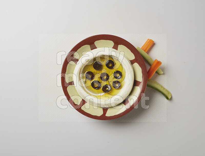 Lebnah garnished with sliced olives in a traditional plate on a white background