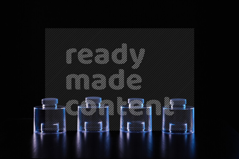 Glassware with rim light in blue and white against black background