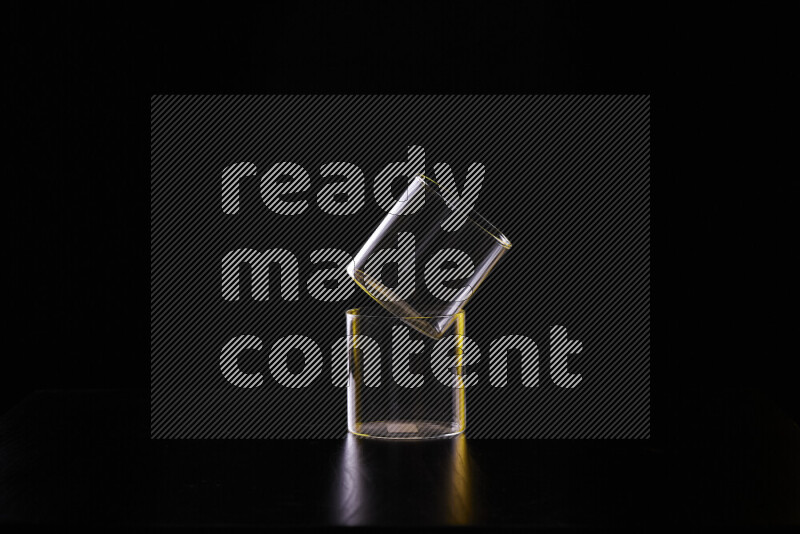 Glassware with rim light in yellow and white against black background