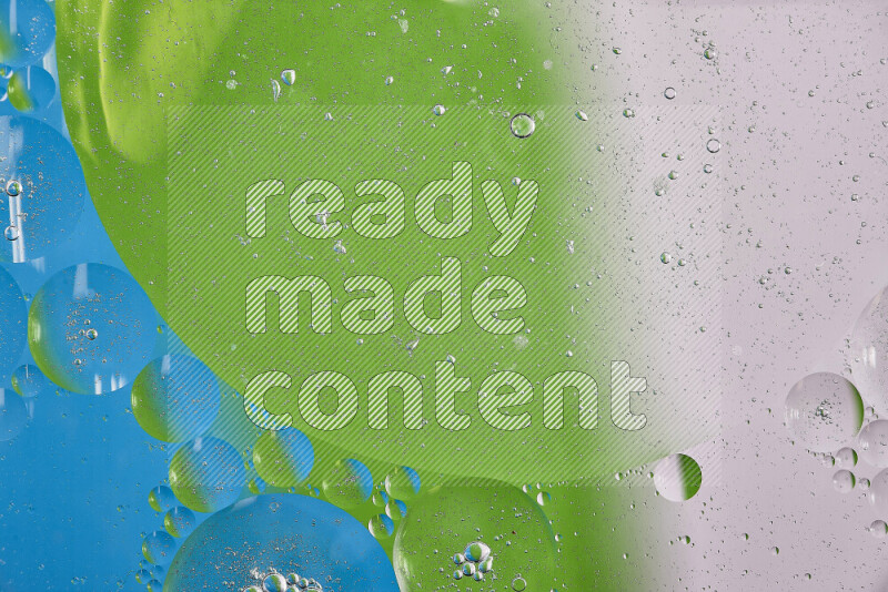 Close-ups of abstract oil bubbles on water surface in shades of white, green and blue