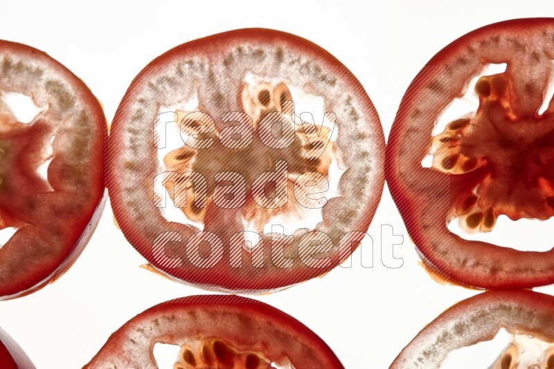 Tomatoes slices on illuminated white background