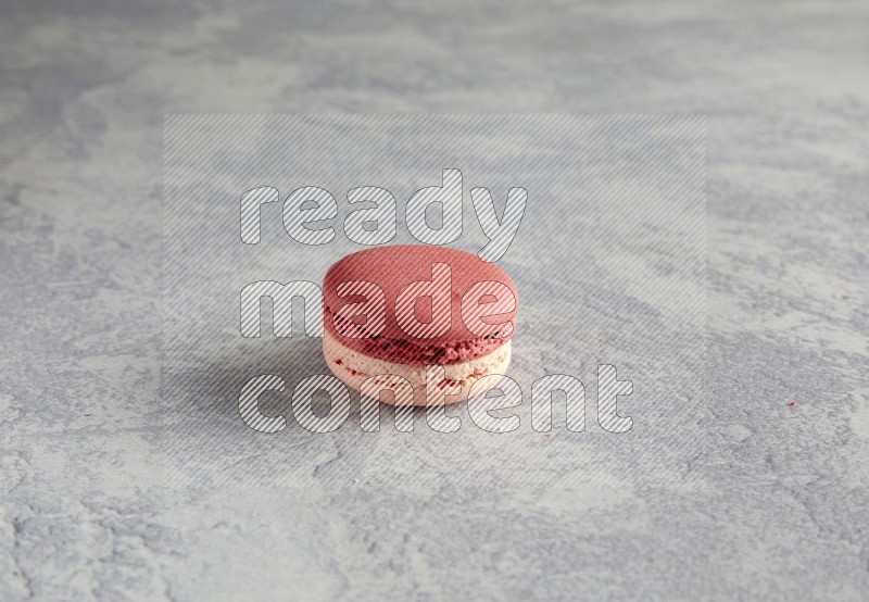 45º Shot of Pink Litchi Raspberry macaron on white  marble background