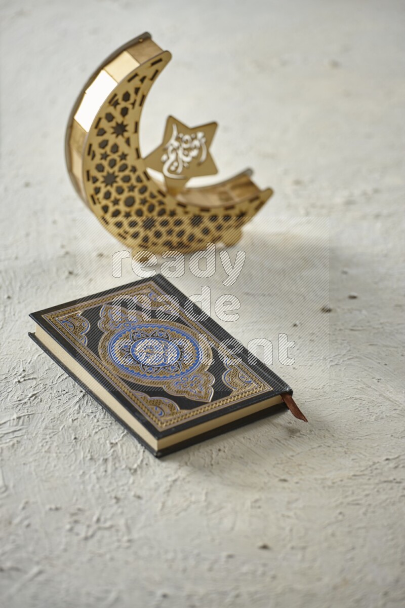 A wooden golden crescent lantern with different drinks, dates, nuts, prayer beads and quran on white background