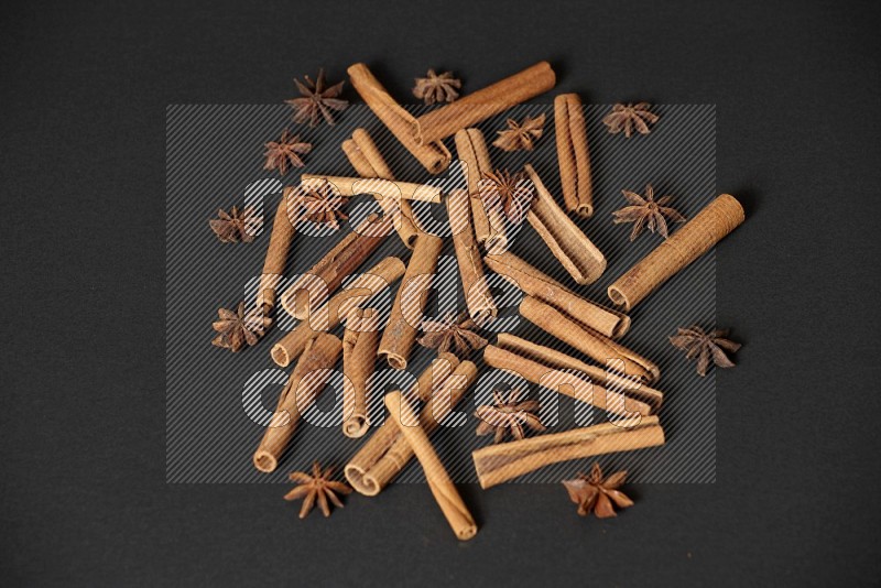 Cinnamon sticks and star anise on black background