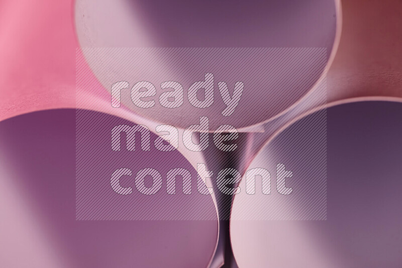The image shows an abstract paper art with circular shapes in varying shades of pink
