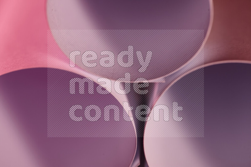 The image shows an abstract paper art with circular shapes in varying shades of pink